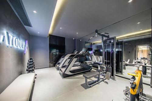 a gym with treadmills and machines in a building at Atour X Hotel Guangzhou Baiyun International Airport Renhe Station in Guangzhou
