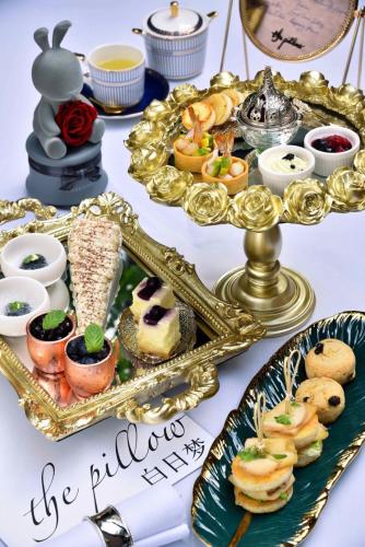 a buffet of food with a mirror and a tray of food at The Drama in Shanghai