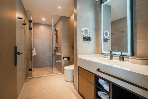 a bathroom with a shower and a sink and a toilet at Atour Hotel Chengdu East Station Greenland 468 Center in Chengdu