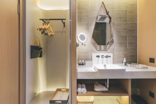 a bathroom with a sink and a mirror at Atour Hotel Shanghai The Bund East Nanjing Road in Shanghai
