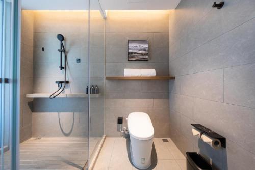 a bathroom with a shower stall and a toilet at Atour Hotel Guangzhou Huangpu Development Zone Baoying in Guangzhou