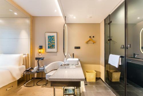 a hotel room with a desk and a shower at Atour X Hotel Shanghai Pudong Zhangjiang Park in Shanghai