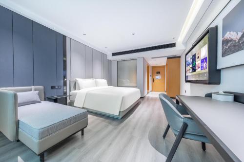 a hotel room with a bed and a desk at Atour X Hotel Guangzhou Baiyun International Airport Renhe Station in Guangzhou