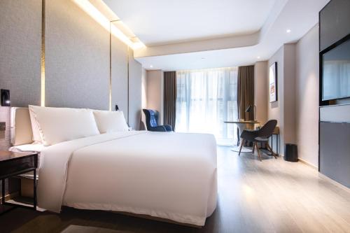 Ένα ή περισσότερα κρεβάτια σε δωμάτιο στο Atour Hotel Yichun Administrative Center