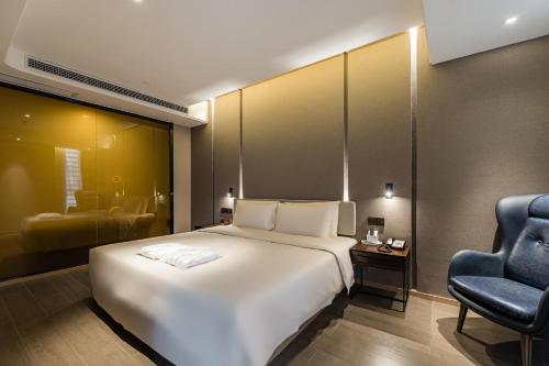 Ένα ή περισσότερα κρεβάτια σε δωμάτιο στο Atour Hotel Ningbo Yinzhou Impression City