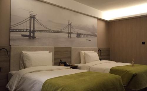 Postel nebo postele na pokoji v ubytování Atour Hotel Dalian Zhongshan Square