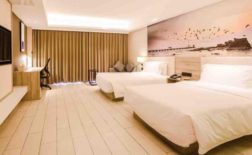 Lova arba lovos apgyvendinimo įstaigoje Atour Hotel Qinhuangdao Xiangxi Sea