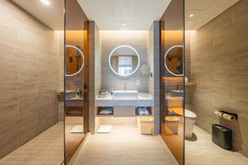 a bathroom with a sink and a mirror at Atour Hotel Shanghai Pudong Airport Chuansha Station in Shanghai