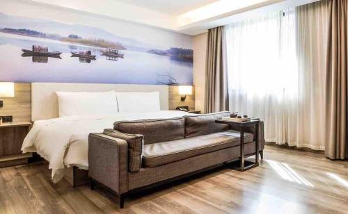 Postel nebo postele na pokoji v ubytování Atour Hotel Dalian Zhongshan Square