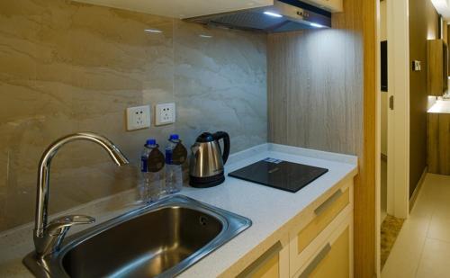 a kitchen counter top with a sink and a mixer at Atour Hotel Qinhuangdao Xiangxi Sea in Qinhuangdao
