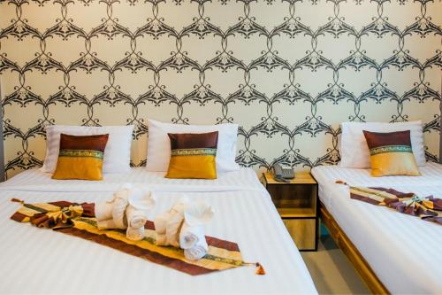 Postel nebo postele na pokoji v ubytování Km Hotel Chiang Mai