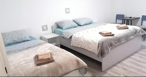 a bedroom with two beds with towels on them at Konak Aleksandar in Mladenovac