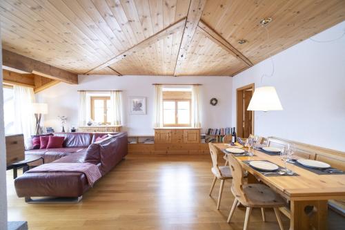 a living room with a couch and a table at Chasa Rontsch Madlaina in Scuol