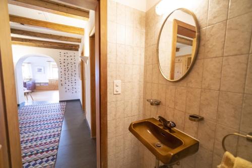 a bathroom with a sink and a mirror at Chasa Rontsch Madlaina in Scuol