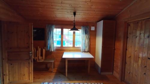 a dining room with a table and a window at Sæbø Camping in Eidfjord