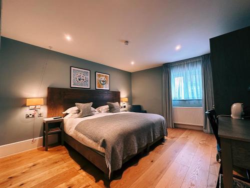 a bedroom with a large bed and a desk at The Georgian, Haslemere, Surrey in Haslemere
