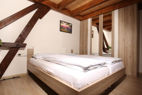 a bedroom with a bed in a room with wooden ceilings at AlbLodges in Bitz