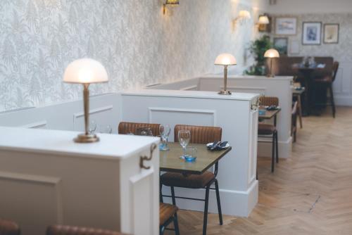 a restaurant with a table with two lamps on it at Florence House Boutique Hotel and Restaurant in Portsmouth