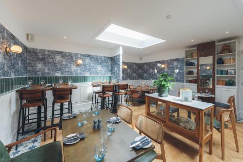 a restaurant with tables and chairs and a bar at Florence House Boutique Hotel and Restaurant in Portsmouth