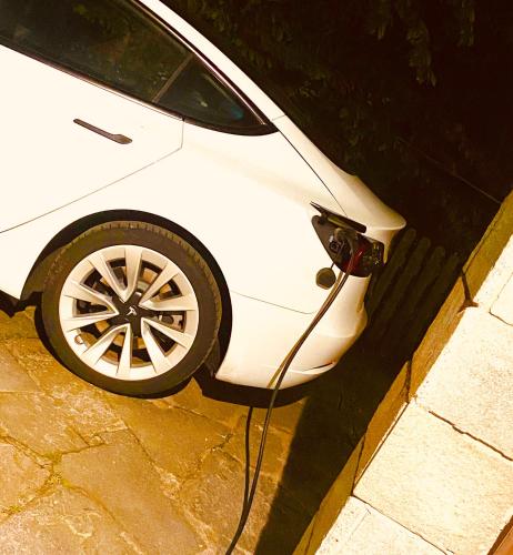 a white car parked on the side of a street at SleepWell in Valganna in Valganna
