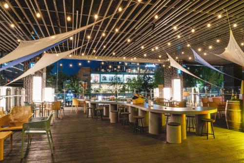 a restaurant with tables and chairs and lights at voco Seoul Gangnam, an IHG Hotel in Seoul