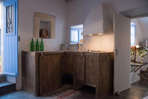 a kitchen with a large wooden island with a fireplace at Abramis Rooms in Mitáta