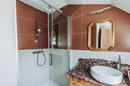 a bathroom with a sink and a glass shower at Ch&acirc;teau Belle Epoque - Chambres d'H&ocirc;tes & G&icirc;tes in Linxe