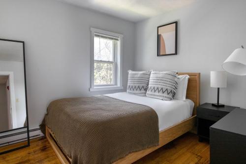 a bedroom with a bed with white walls and a window at South Boston 2br w building wd nr seaport BOS-915 in Boston