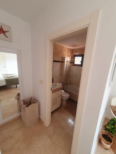 a bathroom with a toilet and a sink at Pure Beach Penthouse & Swimming pool, 3 bedrooms in Los Alcázares