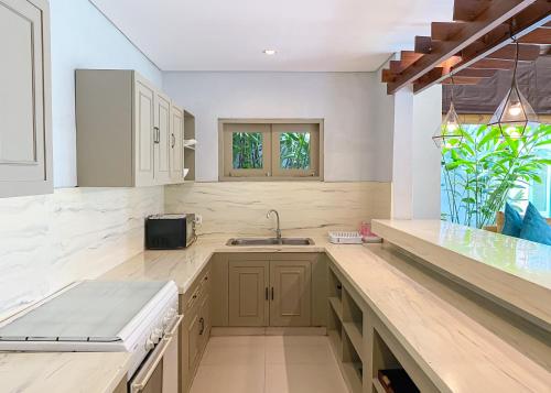 a kitchen with a sink and a counter top at Villa Savannah in Canggu
