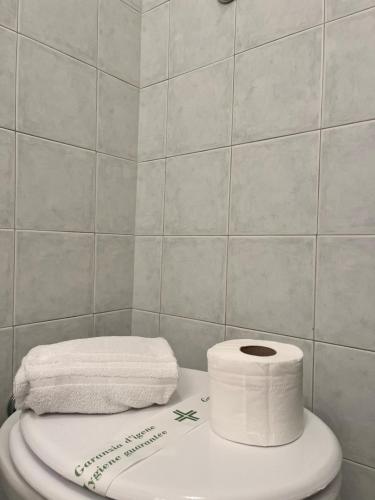a toilet with two rolls of toilet paper on it at Glory house Navona Square in Rome