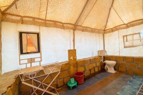 a large room with a toilet in a tent at Bluebird Desert Resort in Jaisalmer