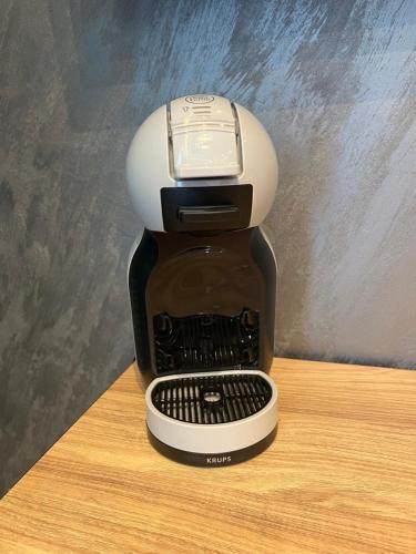 a coffee maker sitting on top of a table at Pleasure Apartment - Belgrade Waterfront in Sajmište