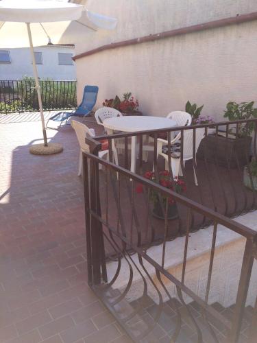 a patio with a table and chairs and an umbrella at Apartment Bogdanovic in Fažana