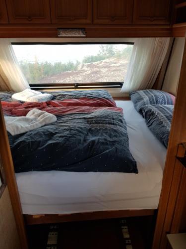 a bed in the middle of a room with a window at Captains` Sea side 