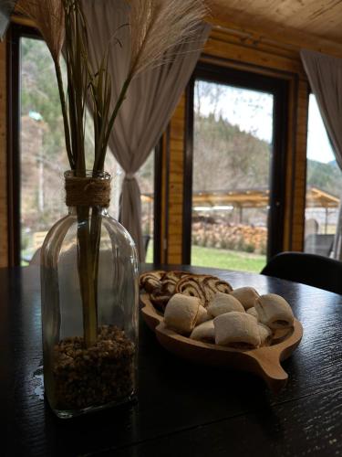 a table with a vase and a plate of cookies at Finașii in Albac