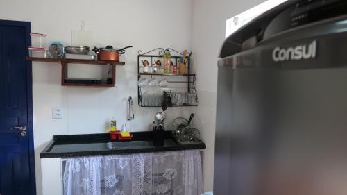 a kitchen with a sink and a stove at Casa Matatiso - casa na Ilha Grande para até 6 pessoas in Angra dos Reis