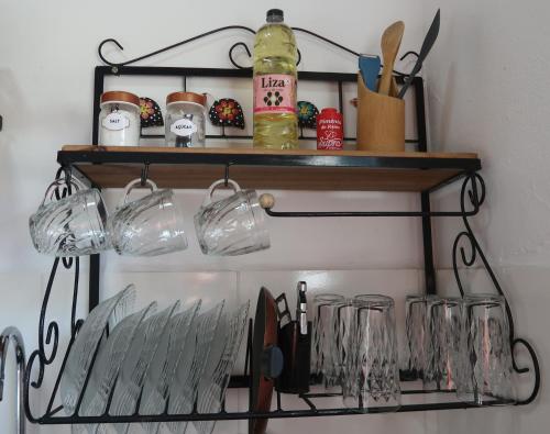 a shelf with glasses and utensils on it at Casa Matatiso - casa na Ilha Grande para até 6 pessoas in Angra dos Reis
