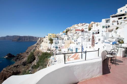 a view of a village on the side of a cliff at Ducato di Oia - Adults Only in Oia