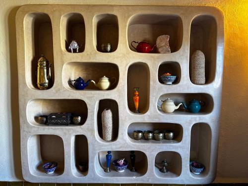 a toy shelf filled with differentiatesiatesiatesiatesiatesktop at Dar Hassan Merzouga in Merzouga