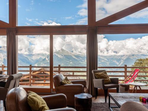 a room with a large window with a view of mountains at Chalet Chalet Jadi by Interhome in Nendaz