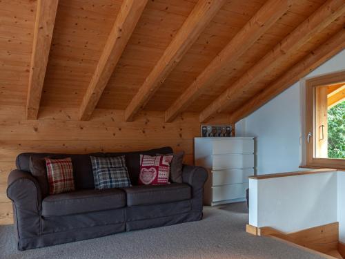 a living room with a couch and a wooden ceiling at Chalet Chalet Jadi by Interhome in Nendaz