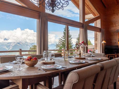 a dining room with a table and a large window at Chalet Chalet Jadi by Interhome in Nendaz
