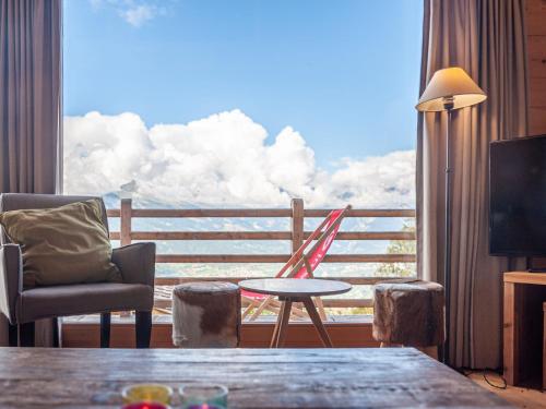 a room with a table and chairs and a large window at Chalet Chalet Jadi by Interhome in Nendaz