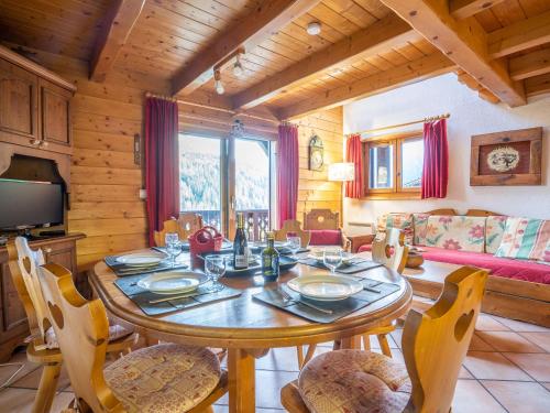 a dining room with a wooden table and chairs at Apartment Les Hauts des Chavants - by Interhome in Les Houches