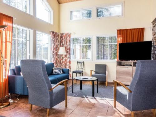 レヴィにあるHoliday Home Levijoutsen by Interhomeのリビングルーム(青い椅子、テレビ付)