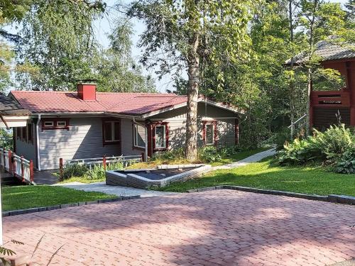 a house with a brick driveway in front of it at Holiday Home Lomaranta by Interhome in Paksalo