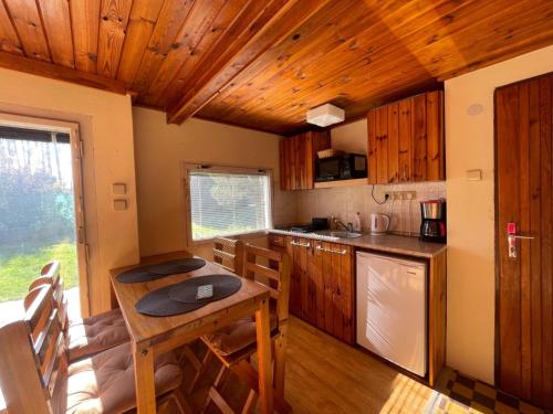 a kitchen with wooden cabinets and a table in a room at Holiday Home Zhorska by Interhome in Planá nad Lužnicí