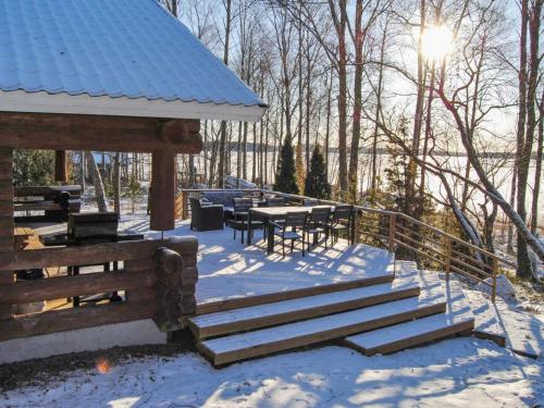 a gazebo with benches and tables in the snow at Holiday Home Kaaposniemi by Interhome in Miehoila