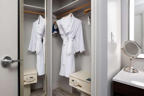 a bathroom with white towels hanging in a closet at Hilton Galveston Island Resort in Galveston